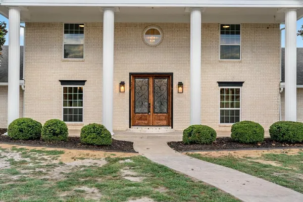 a front view of a house with garden