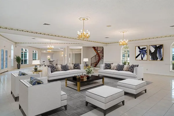 a living room with furniture and a chandelier