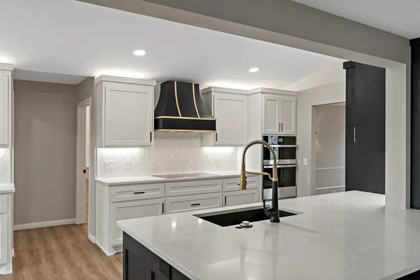 a kitchen with granite countertop a sink stainless steel appliances and cabinets