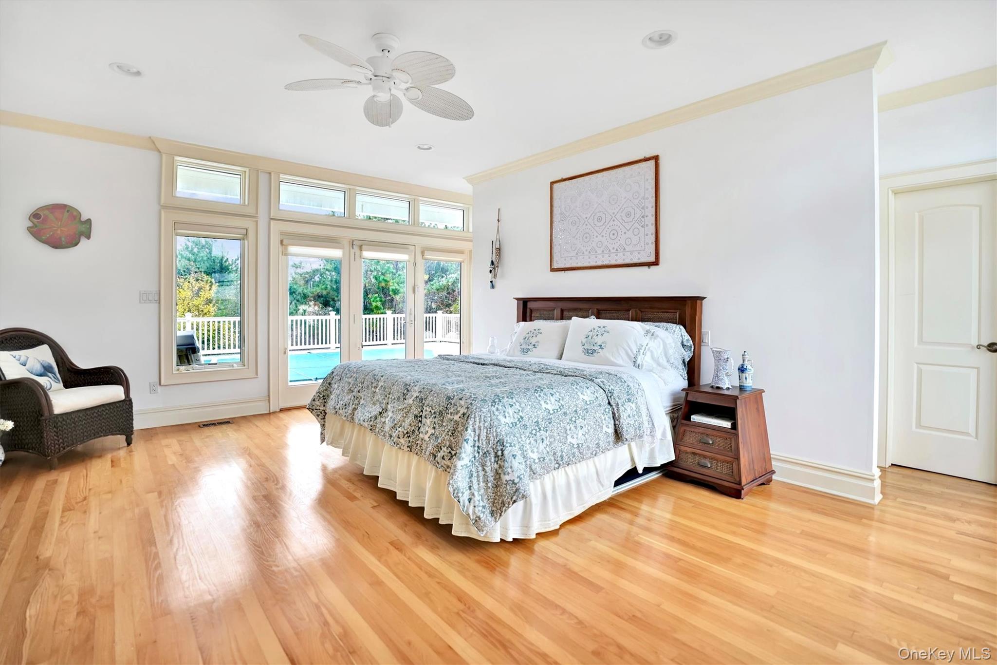 605 Dune Road Westhampton, NY 11978 - Photo 18 of 44 First Floor Primary Bedroom with access to exterior, light wood-style floors, a ceiling fan, ornamental molding, and recessed lighting