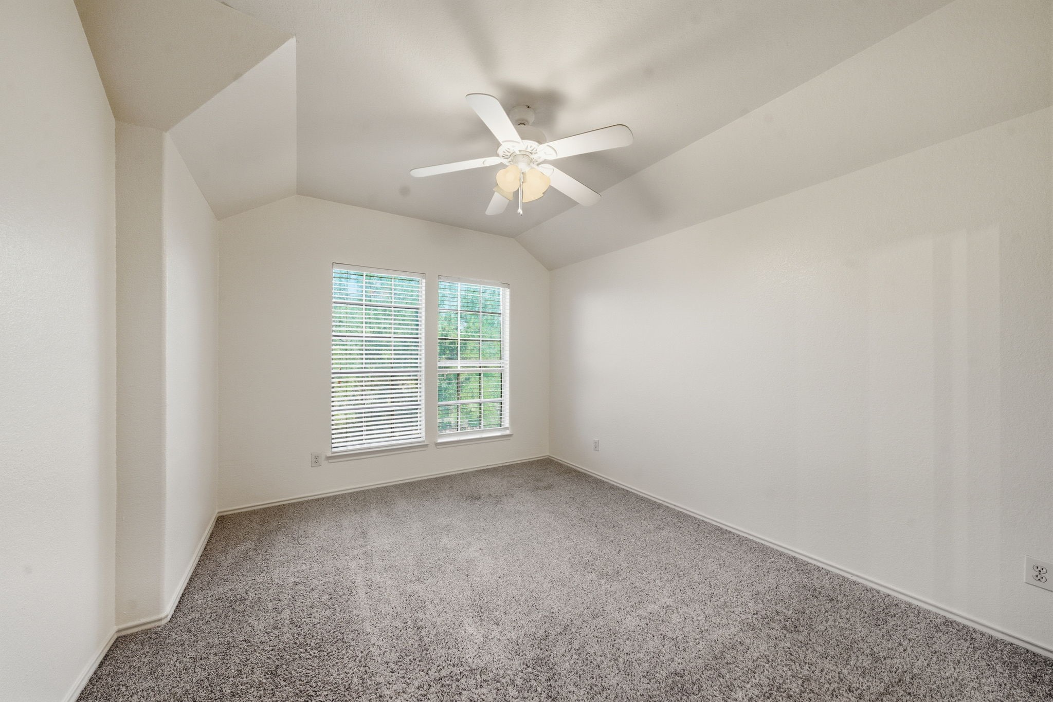 23139 Tranquil Spring Lane Katy, TX 77494 - Photo 19 of 22 an empty room with a window and a fan
