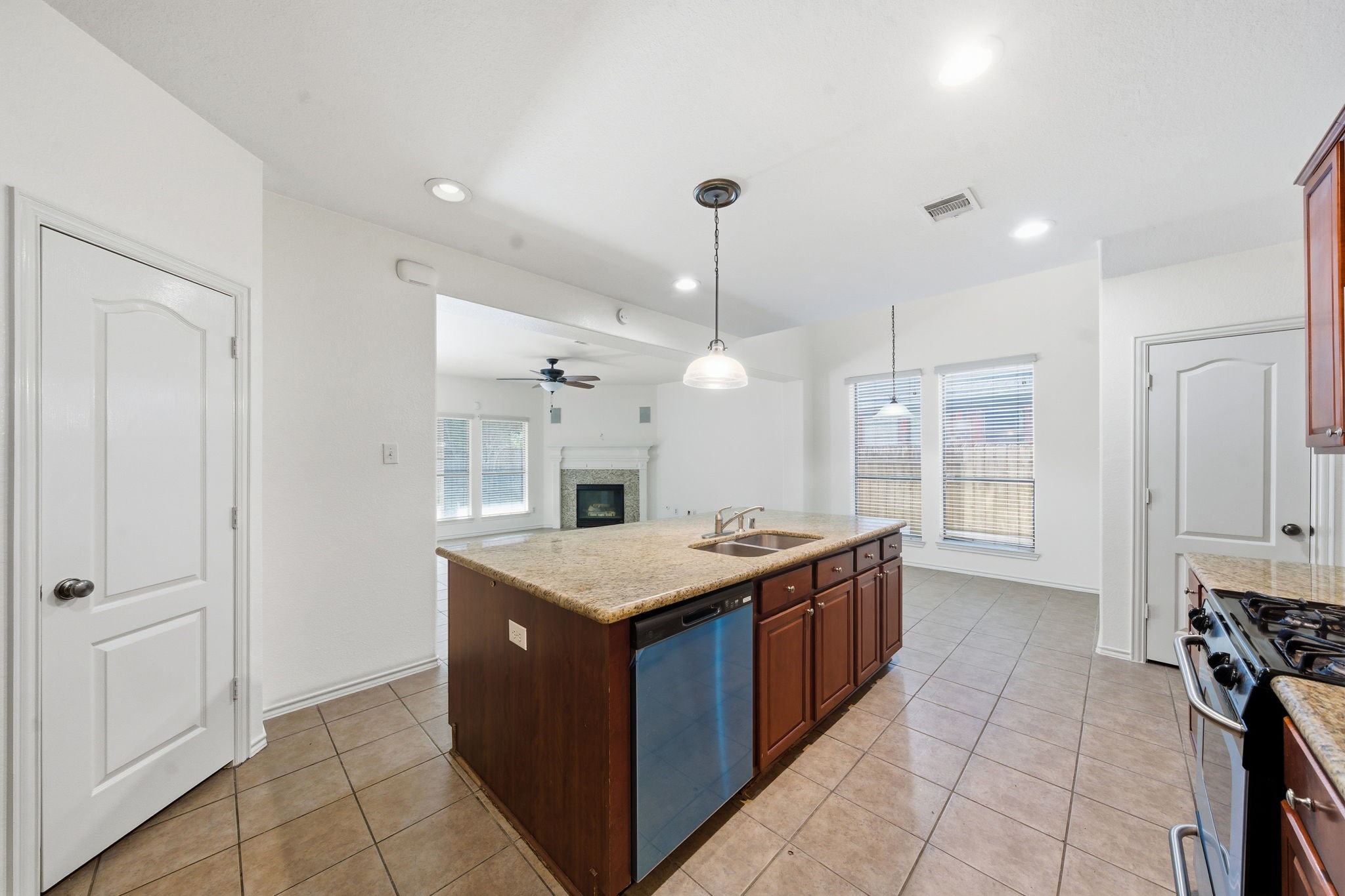 23139 Tranquil Spring Lane Katy, TX 77494 - Photo 8 of 22 a kitchen with a stove a sink a refrigerator and a counter top space