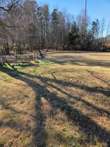 a view of a yard with trees