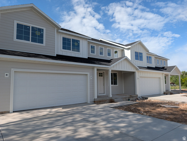 626 East 800 S Street, Unit 16 Springville, UT 84663 - Photo 2 of 6 Contemporary multi-unit residence featuring light gray horizontal siding and contrasting white vertical board and batten accents