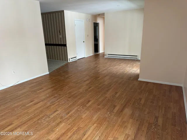 a view of a room with wooden floor