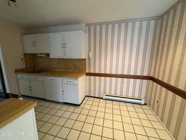 a view of a utility room with cabinets