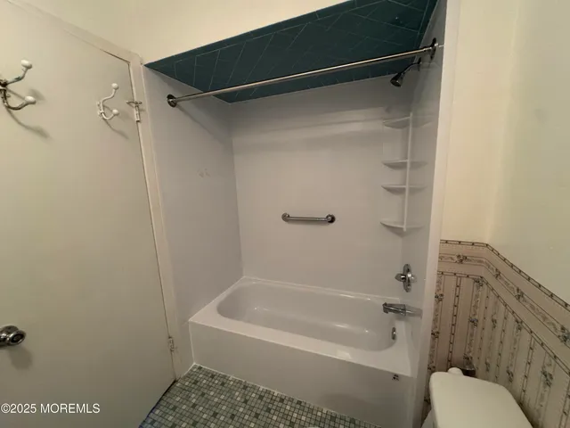 a bathroom with a shower and a toilet