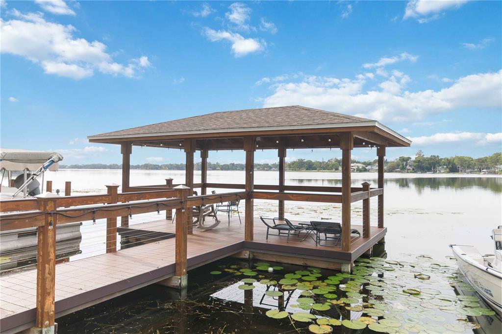 2500 Lee Road, Unit 244 Winter Park, FL 32789 - Photo 24 of 26 a front view of a house with lake view and a large tree
