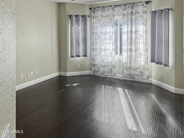 a view of wooden floor and windows in a room
