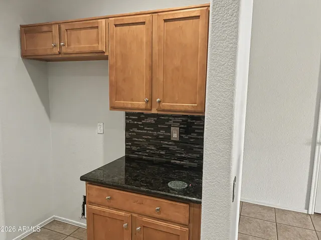 a bathroom with a granite countertop sink and cabinets