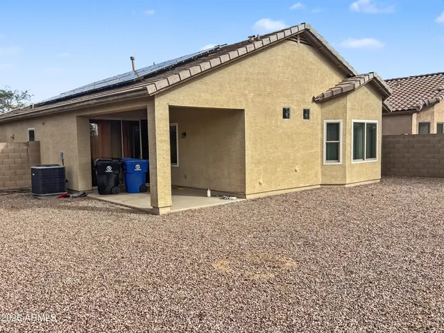 a view of a house with wooden fence
