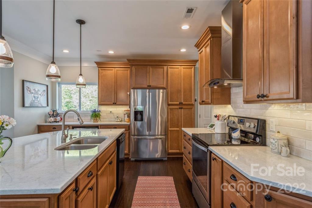 739 West Cheval Drive Fort Mill, SC 29708 - Photo 17 of 36 a kitchen with stainless steel appliances granite countertop a sink refrigerator and cabinets