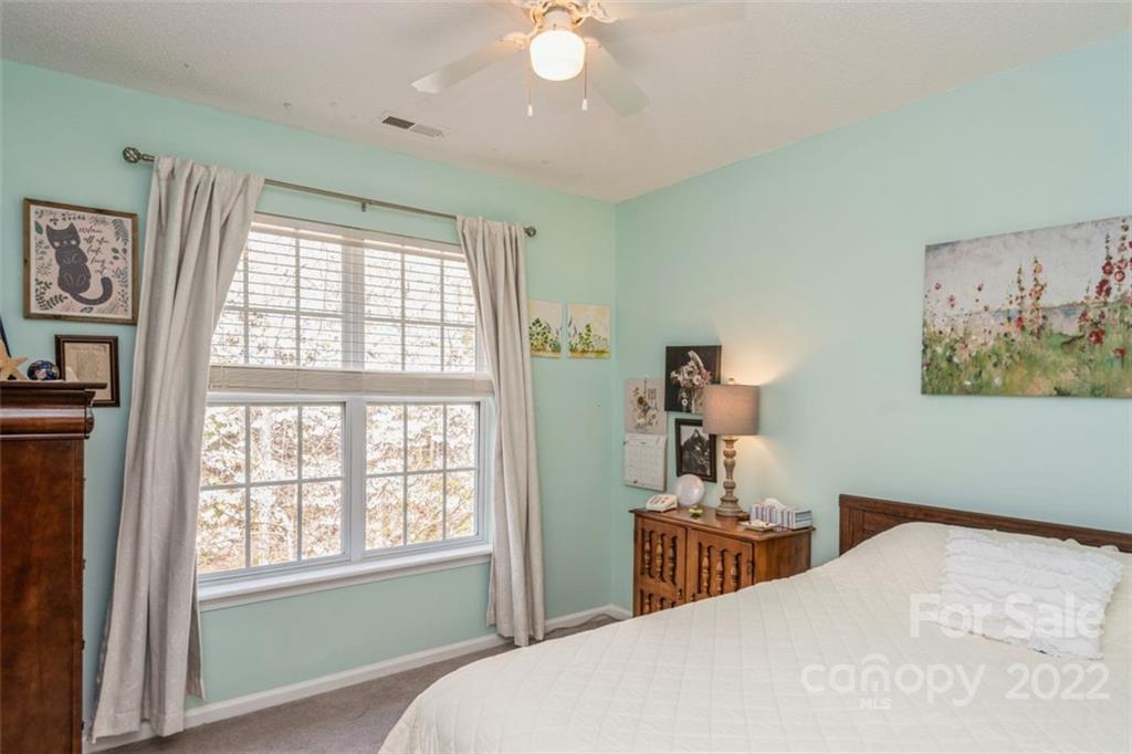 739 West Cheval Drive Fort Mill, SC 29708 - Photo 28 of 36 a bedroom with a bed and a chandelier