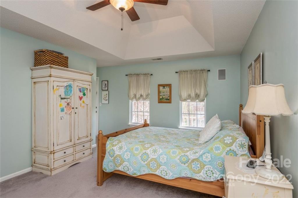 739 West Cheval Drive Fort Mill, SC 29708 - Photo 33 of 36 a bedroom with a large bed and a chandelier