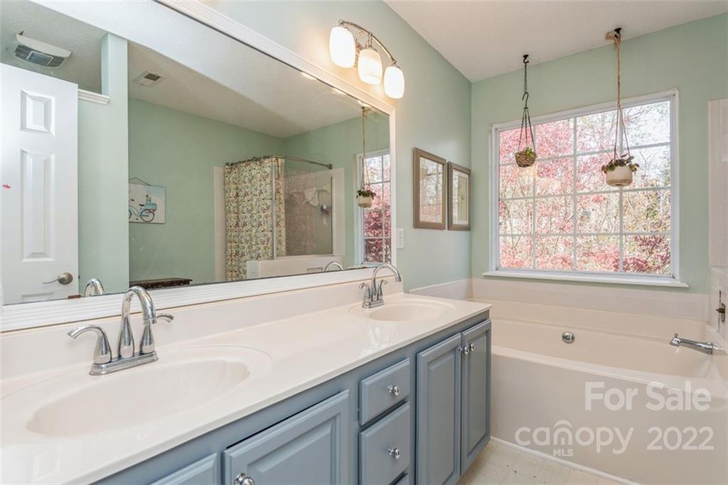 739 West Cheval Drive Fort Mill, SC 29708 - Photo 34 of 36 a bathroom with a sink double vanity granite tub shower and a mirror