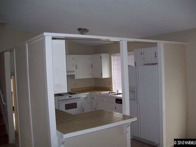 1835 Becky Court Reno, NV 89503 - Photo 4 of 4 a kitchen with a refrigerator and a sink