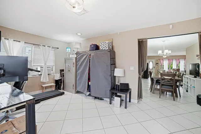 a living room with furniture a computer on desk and chair