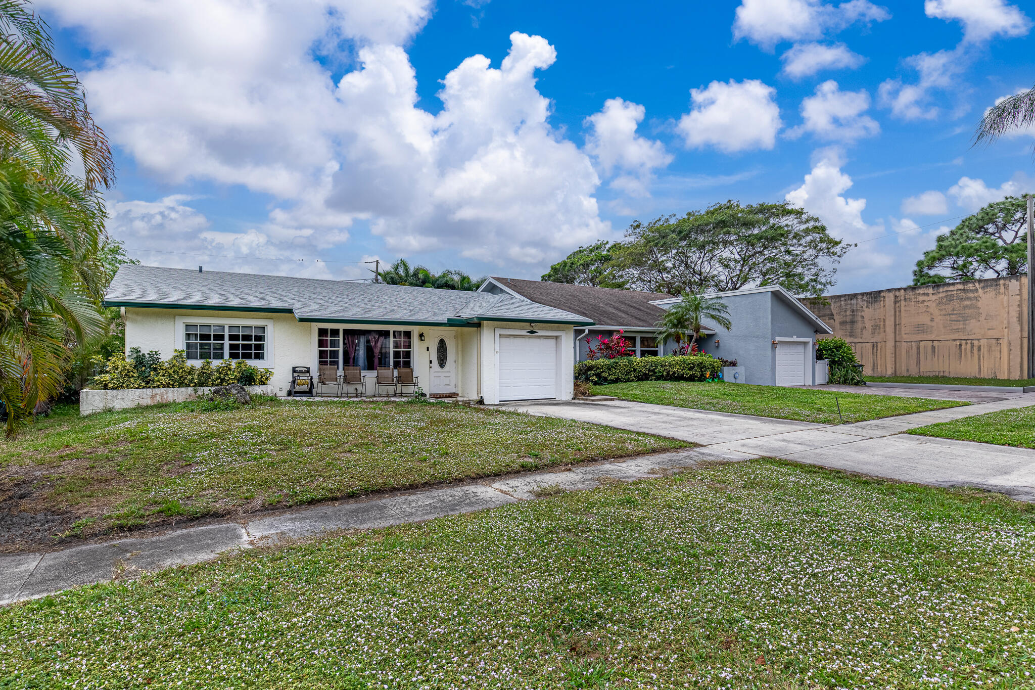 564 Northwest 55th Street Boca Raton, FL 33487 - Photo 2 of 26 a front view of a house with a garden