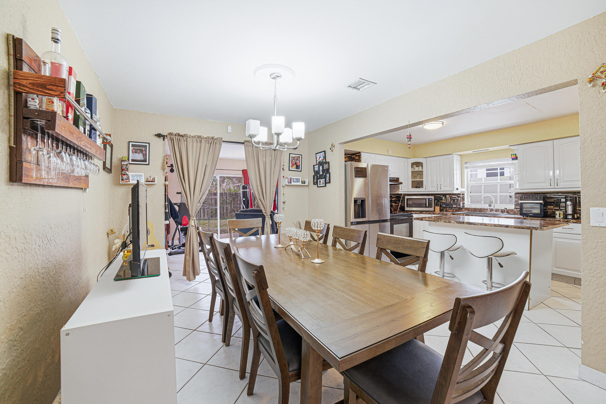 564 Northwest 55th Street Boca Raton, FL 33487 - Photo 9 of 26 a view of a dining room with furniture and chandelier