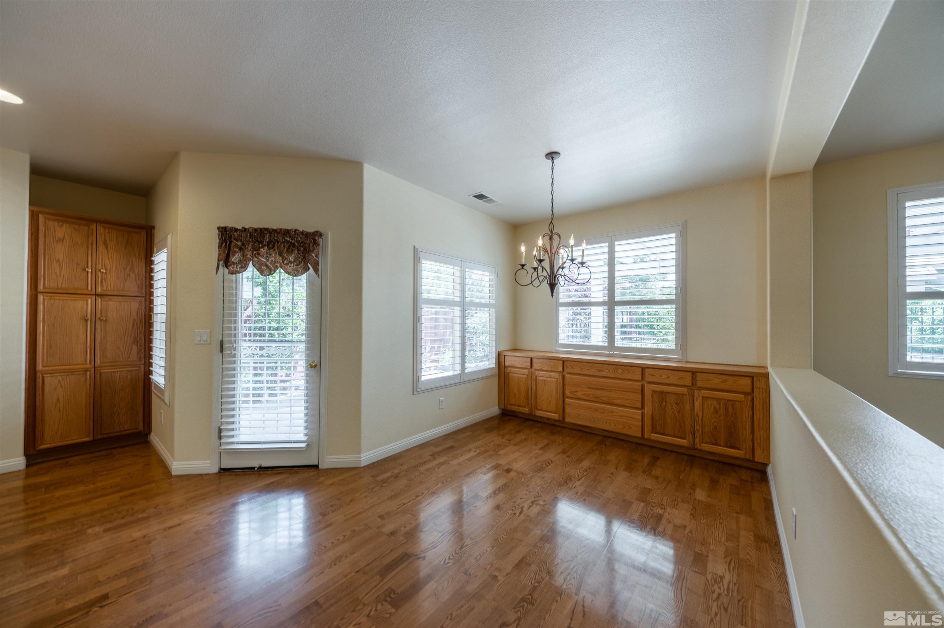 1416 Wild Wolf Way Reno, NV 89521 - Photo 13 of 39 a large room with wooden floor and windows