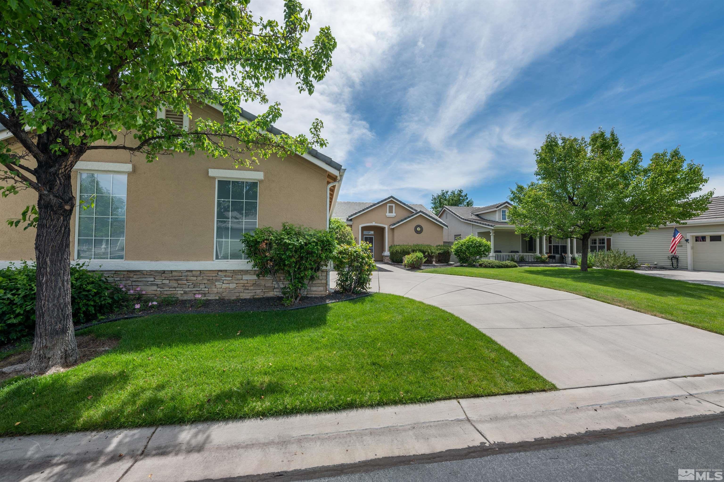 1416 Wild Wolf Way Reno, NV 89521 - Photo 2 of 39 a front view of a house with a yard