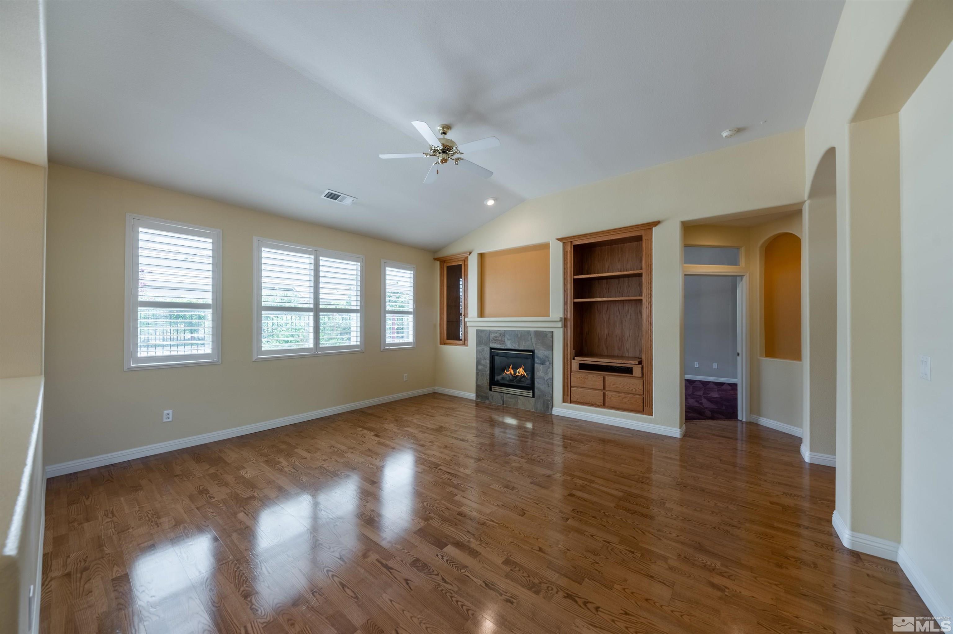 1416 Wild Wolf Way Reno, NV 89521 - Photo 9 of 39 a view of an empty room with a window and wooden floor