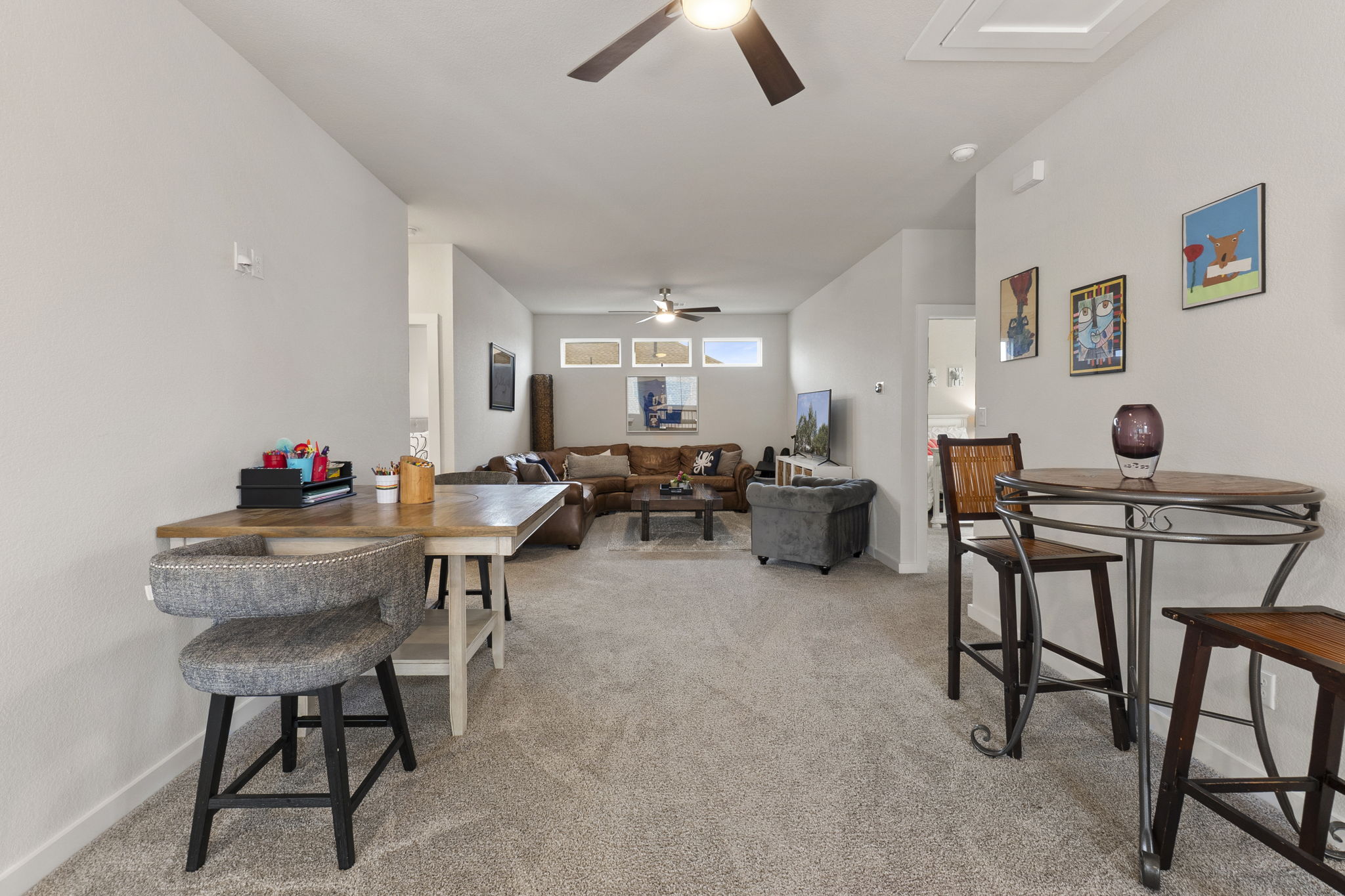 460 Constitution Way Kyle, TX 78640 - Photo 24 of 40 Expansive open-concept living area featuring light-toned carpeting and neutral wall colors