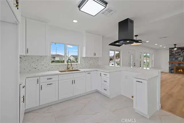 a kitchen with stainless steel appliances a sink and cabinets