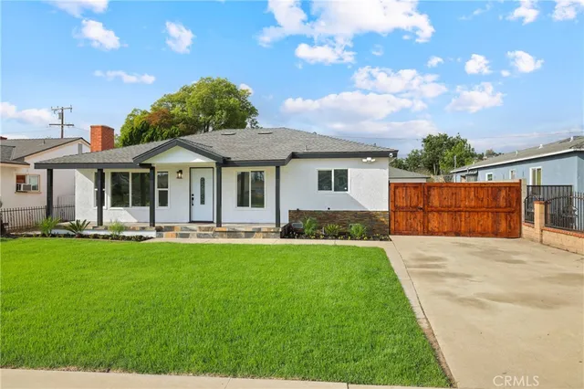 a front view of a house with yard patio and green space