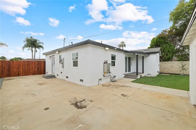 a view of a white house with a yard and garage
