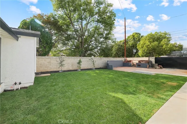 a view of a backyard with sitting area