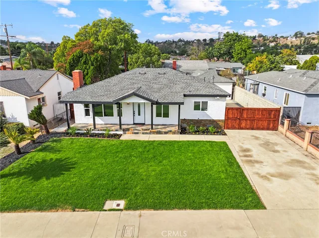 a aerial view of a house with a garden and a patio