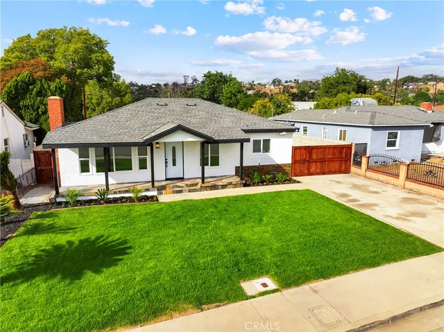 a view of a house with a backyard patio and swimming pool