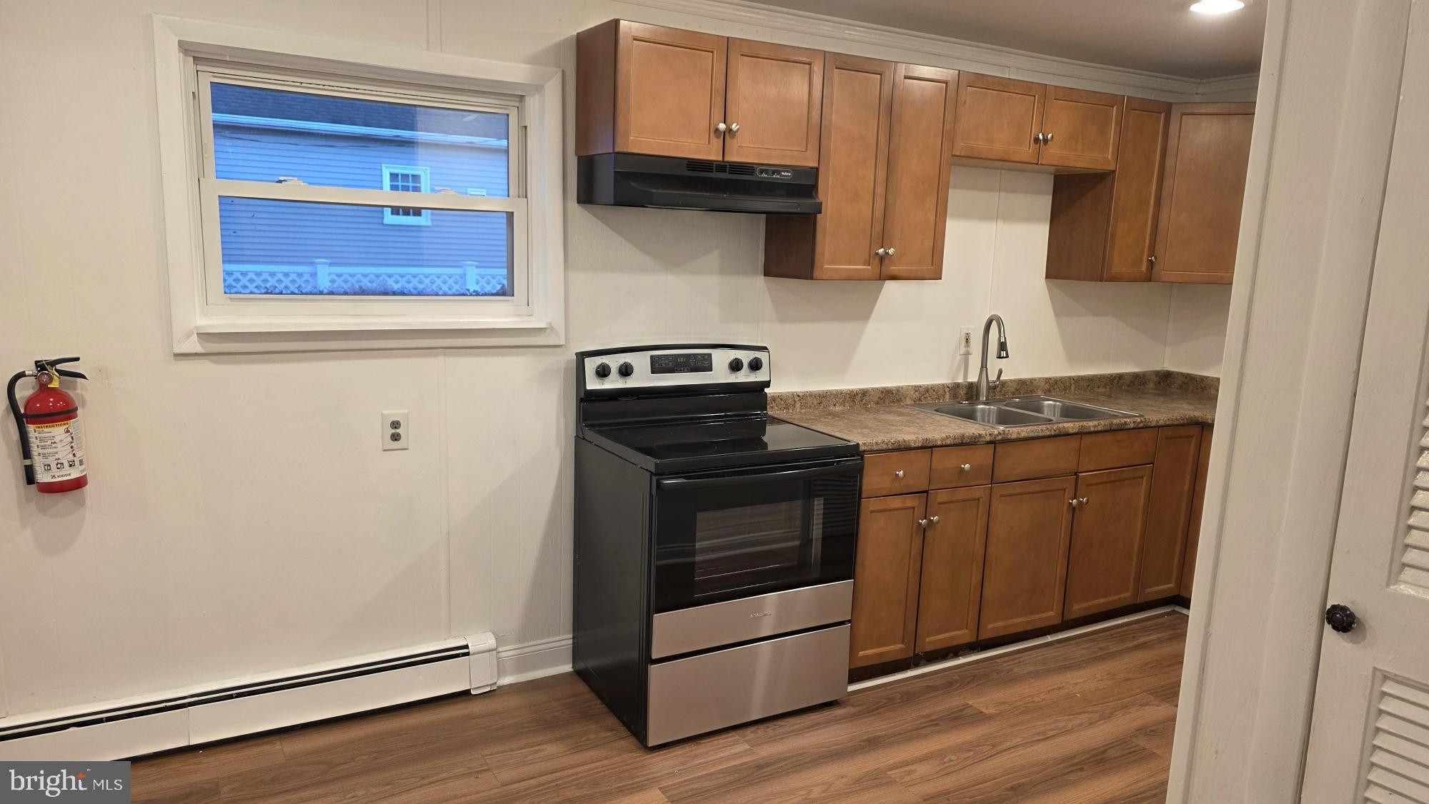 239 J Street Carneys Point, NJ 08069 - Photo 11 of 19 a kitchen with granite countertop a stove and a sink