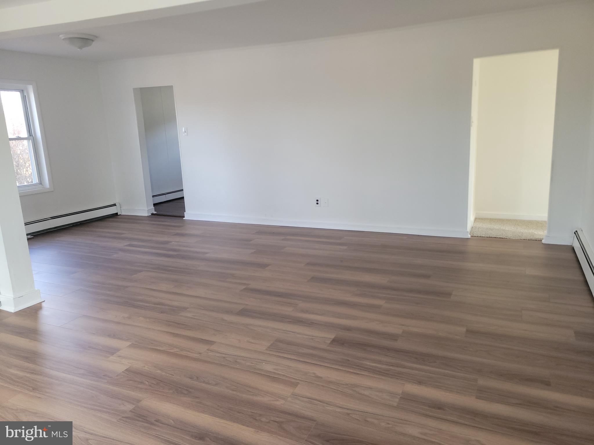 239 J Street Carneys Point, NJ 08069 - Photo 7 of 19 a view of an empty room and wooden floor