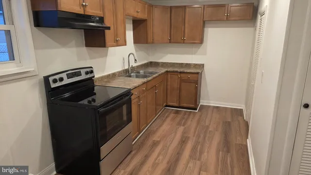 a kitchen with a stove and a refrigerator