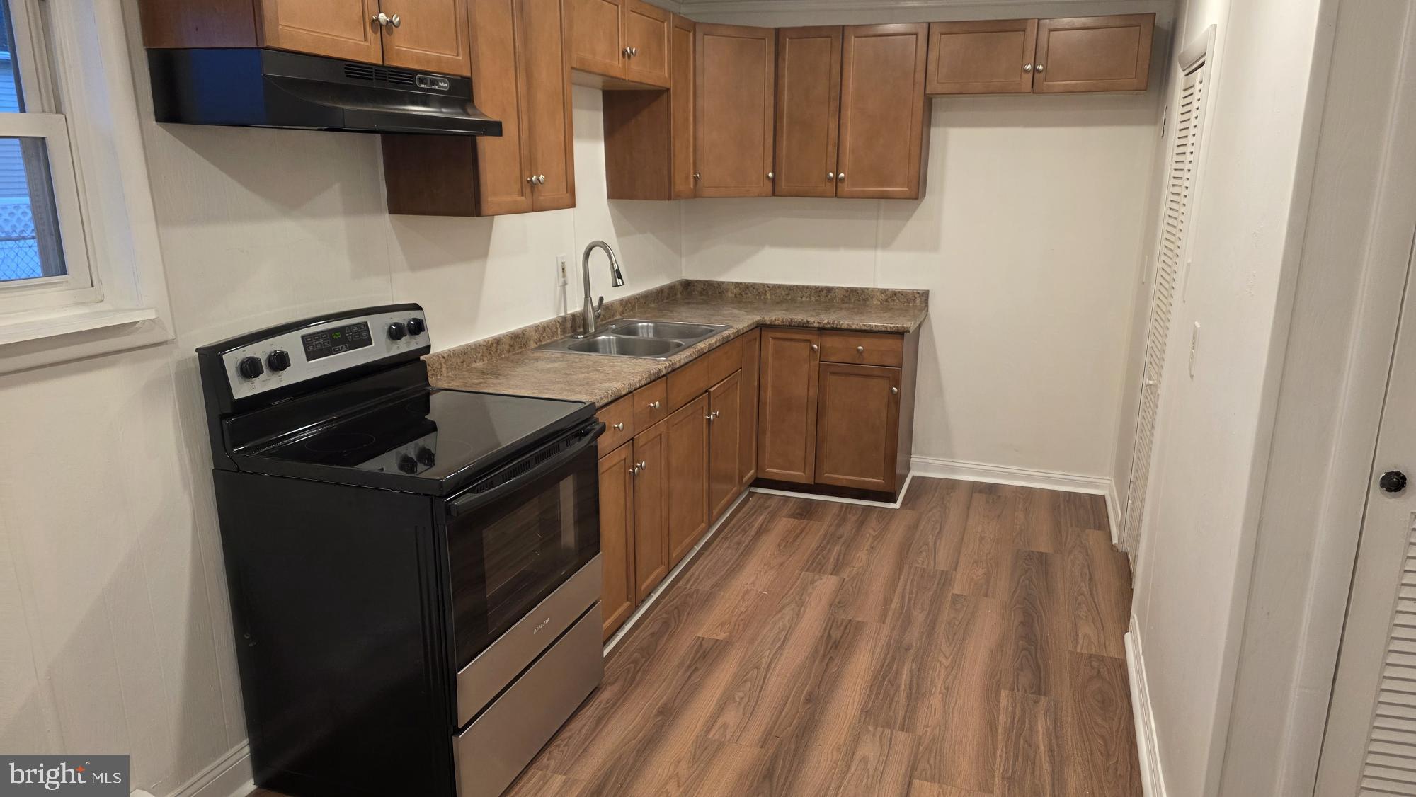 239 J Street Carneys Point, NJ 08069 - Photo 10 of 19 a kitchen with a stove and a refrigerator