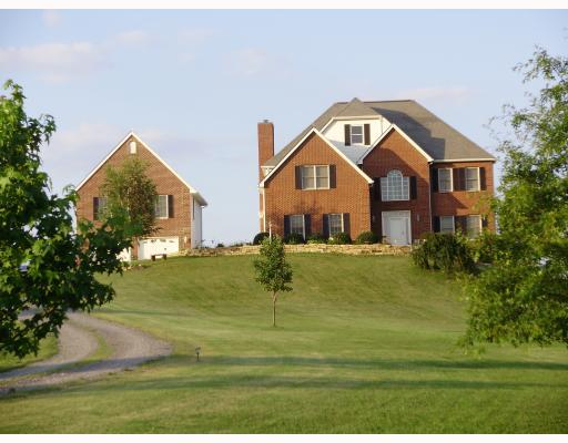 Exterior Front. Wonderful Home with sunny studio above 26  x 26  detached garage;  Beautiful Stone Landscape Walls; Pines, deciduous, & Fruit Trees; Large Garden Area; Road Entry of driveway is wired for lighting;  One &1/2 Miles to Rt 19.