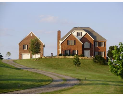 Exterior Front. 26  x 26  Studio above detached garage is finished with hard wood floors.  Verizon phones, Armstrong Cable, Two active wells and 80 gallon hot water heater, and a sand mound  service the home.  Lancaster Township will permit horses.