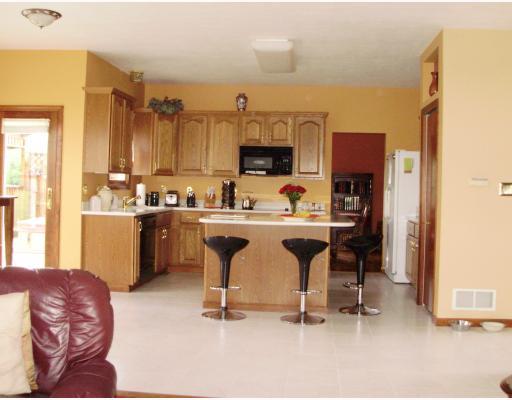 137 Liberty Road Harmony, PA 16037 - Photo 11 of 18 Kitchen. Gourmet Kitchen with Large Center Island, Corian Counter Tops, 36" Tall Oak Cabinets, built in ceramic top electric range, dishwasher,microwave & refrigerator.Ceramic Tile Floor; 2 Storage Pantries & access to TREX Deck, 12 ft Gazebo and 5 person Hot Tub!