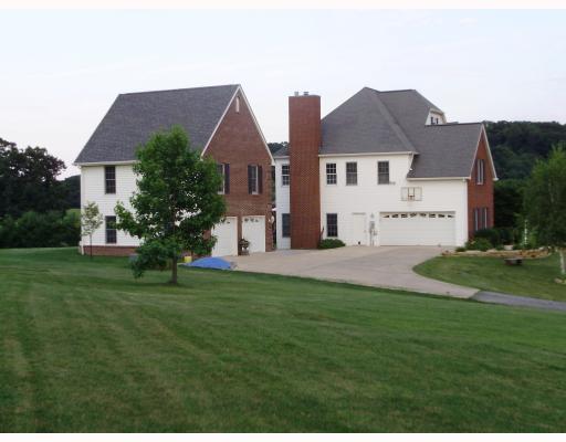 Exterior Front. Large Concrete parking areas at Garages;.