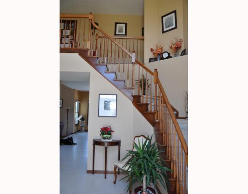 1st Floor Plan. Dramatic Turned Stair Case in 11  x 12  , Two Story Entry Foyer! Transom window above door unit! Ceramic Tile flooring; Entry door is flanked by 2 closets. Medium Oak Stain on Wood Trim and Wood interior doors; Home is pre-wired for security system.