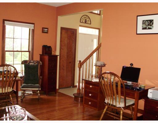 Living Room. Easy to care Hard Wood floors in Spacious Living Room; windows are all wood framed and include custom window shades.  1st Floor offers 9  and two story ceilings!