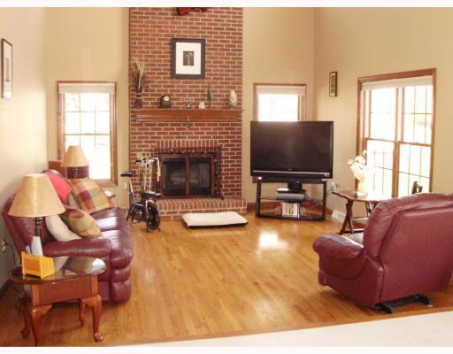 137 Liberty Road Harmony, PA 16037 - Photo 9 of 18 Den/Family/Great Room. 17 x13 Step Down Family Room with 2 story height! Lots of Windows offer a panoramic view of surrounding property; Brick hearth enhances the floor to ceiling fire place. Second Floor Balcony overlooks family room.