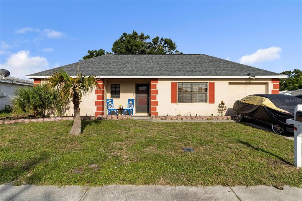9931 Crofton Lane Port Richey, FL 34668 - Photo 1 of 1 a front view of a house with garden