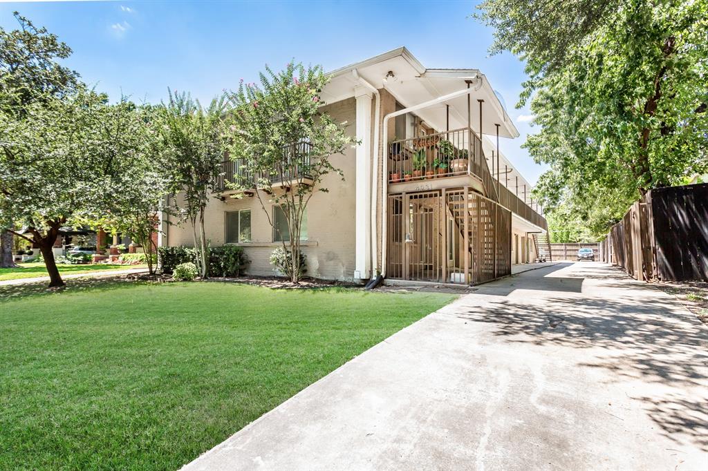 4931 Junius Street, Unit 8 Dallas, TX 75214 - Photo 1 of 31 a view of a white house with a big yard and large tree
