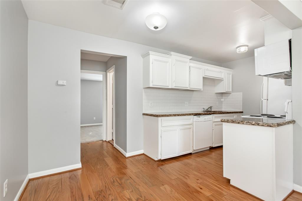 4931 Junius Street, Unit 8 Dallas, TX 75214 - Photo 11 of 31 a kitchen with granite countertop a sink stove and refrigerator