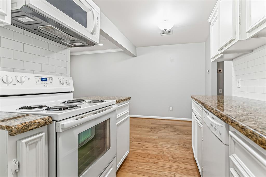 4931 Junius Street, Unit 8 Dallas, TX 75214 - Photo 18 of 31 a stove top oven sitting inside of a kitchen