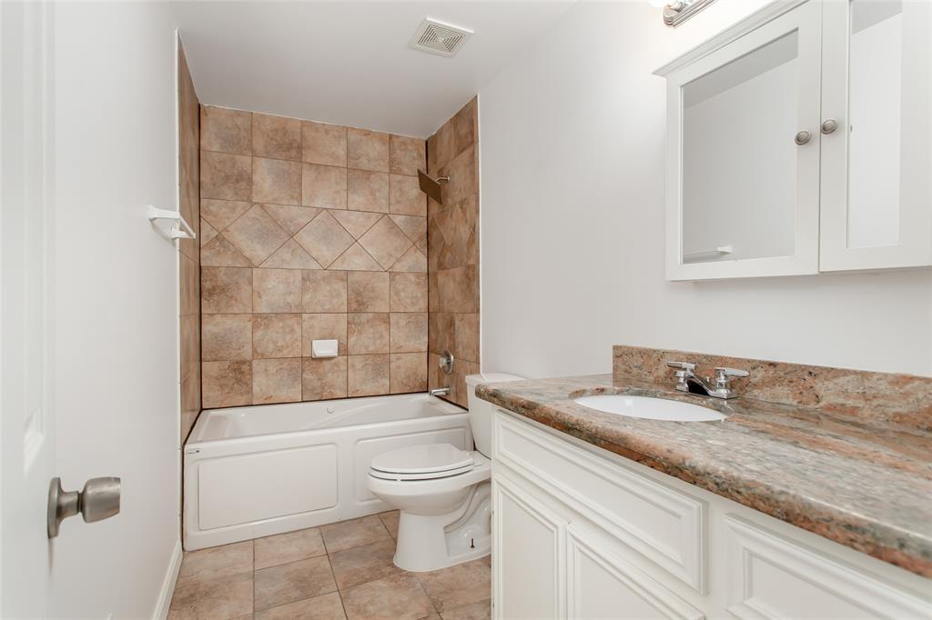 4931 Junius Street, Unit 8 Dallas, TX 75214 - Photo 20 of 31 a bathroom with a granite countertop sink a toilet and shower