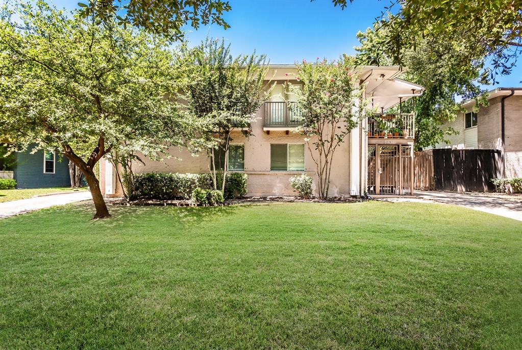 4931 Junius Street, Unit 8 Dallas, TX 75214 - Photo 30 of 31 a view of a house with backyard and a tree